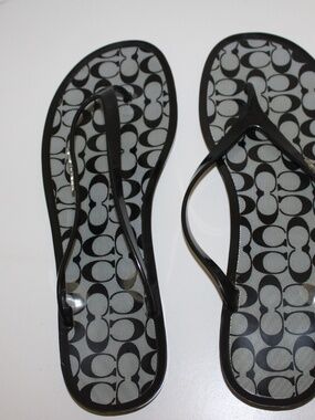 Coach Lyra Jelly Flip-Flop Sandals in black with the signature Coach "C"